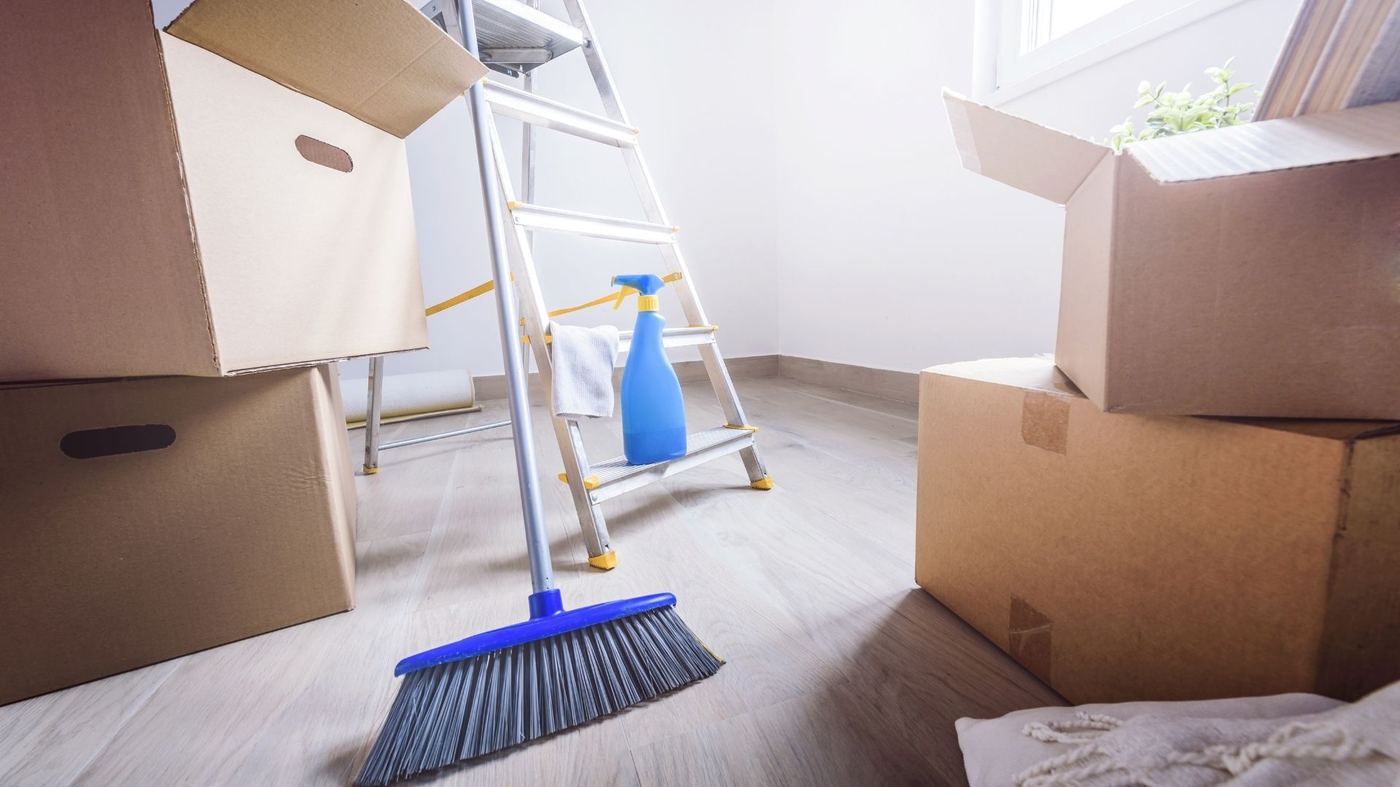 Move-out cleaning with boxes and broom in Franklinton, NC